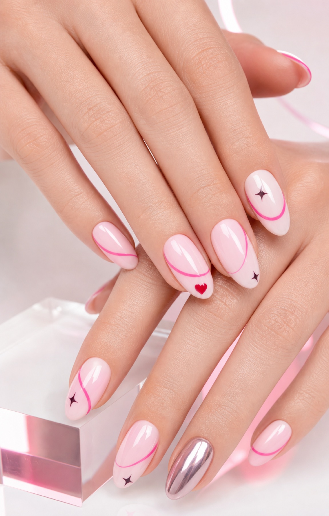 Milky pink manicure with graphic pink lines, stars and a small heart
